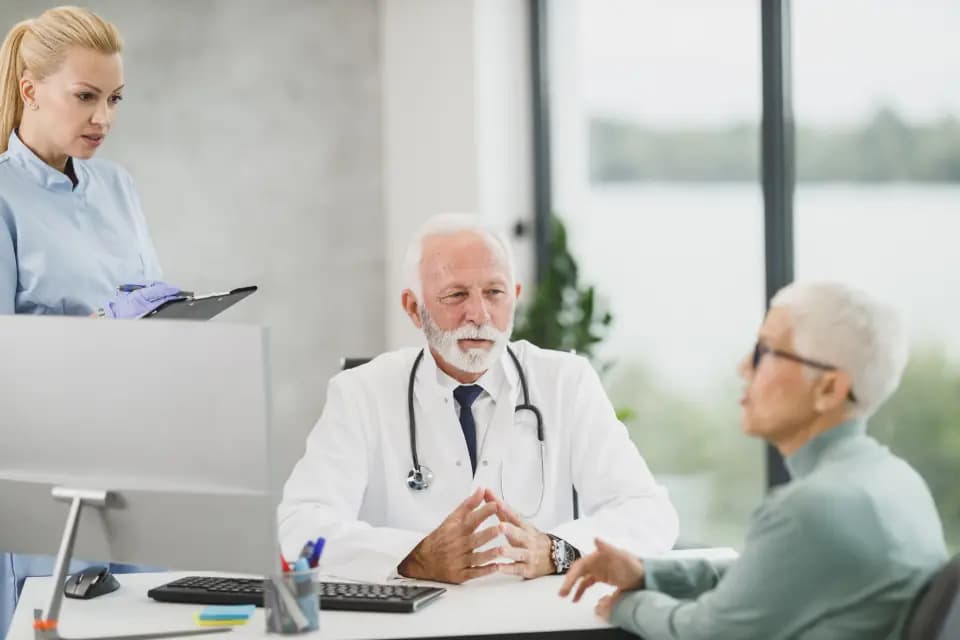 A doctor and nurse meeting a patient in a bright clinic