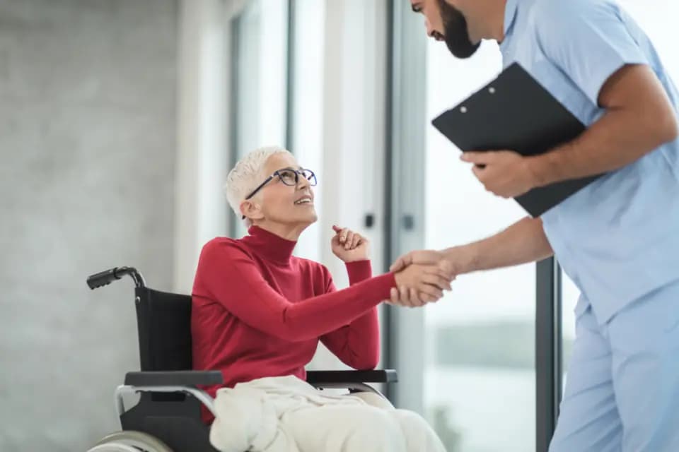 A nurse greeting a patient with a handshake