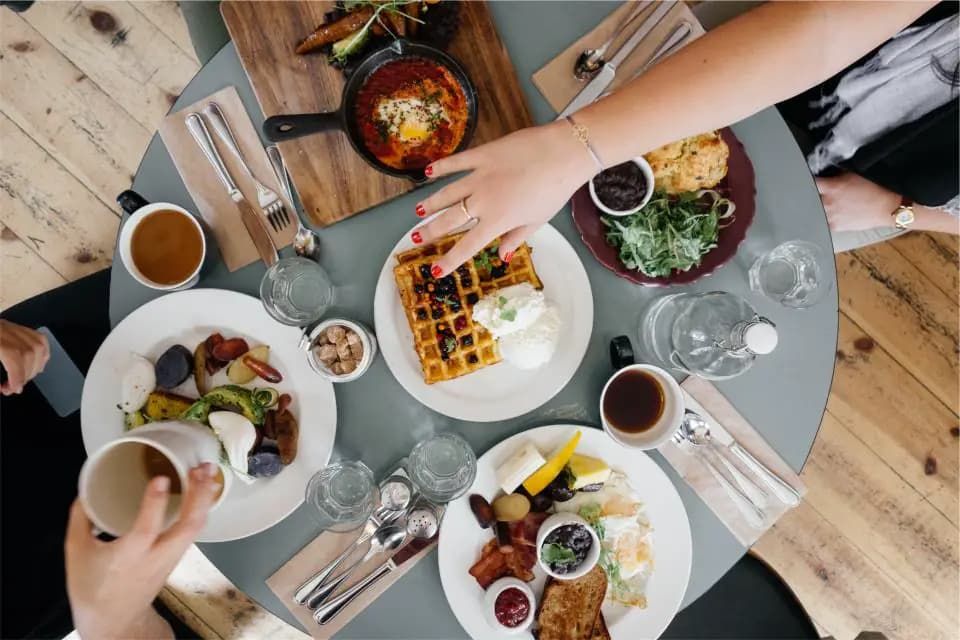 Plates of breakfast shared around a table
